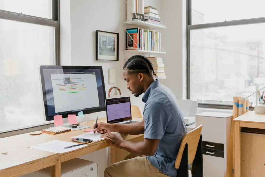 African American man working at a desk in a light filled modern office