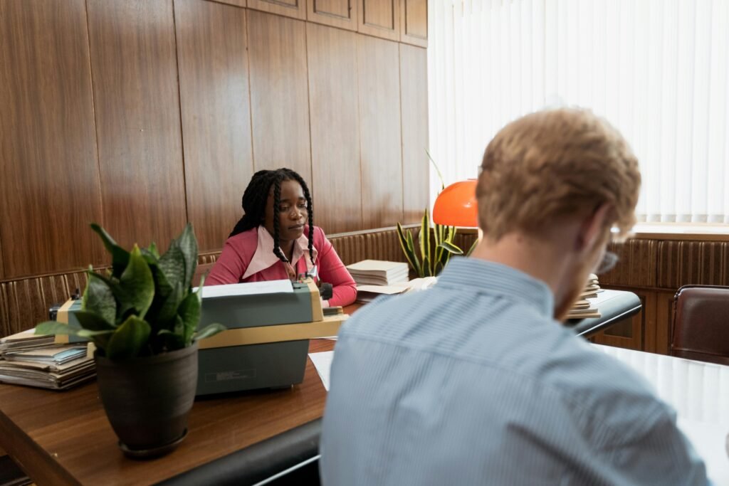 Two colleagues collaborating in a vintage office setting with wooden decor